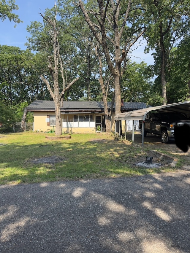 1505 Grove Dr, West Tawakoni, TX 75474 - view of front of property with a front lawn and solar panels