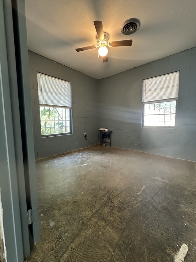 1505 Grove Dr, West Tawakoni, TX 75474 - unfurnished room featuring concrete block wall and a ceiling fan