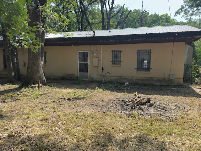 1505 Grove Dr, West Tawakoni, TX 75474 - back of house featuring concrete block siding and metal roof