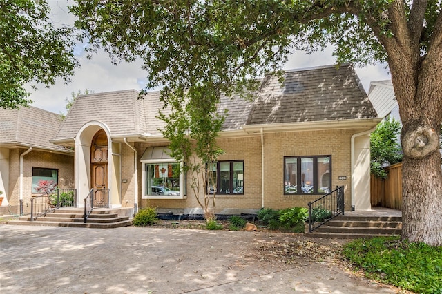 3552 Granada Ave Unit B, University Park, TX 75205 - view of front of home featuring brick siding, roof with shingles, and mansard roof