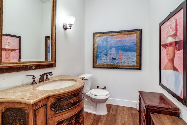 3552 Granada Ave Unit B, University Park, TX 75205 - bathroom with wood finished floors, toilet, baseboards, and vanity