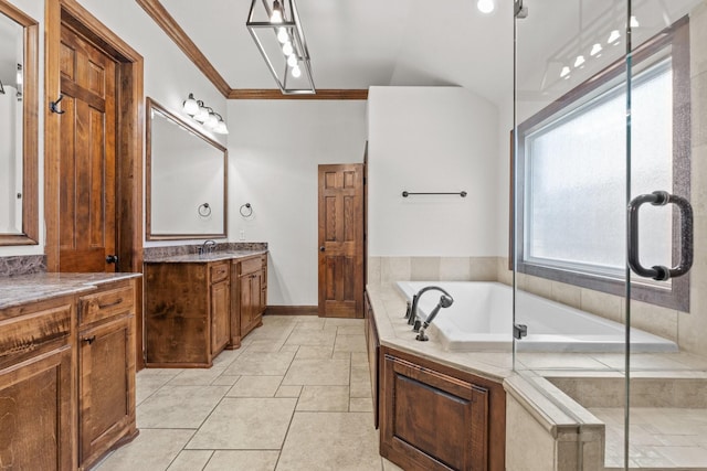 2100 Tremont Ave, Fort Worth, TX 76107 - bathroom featuring crown molding, a garden tub, two vanities, and baseboards