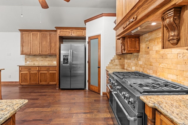 2100 Tremont Ave, Fort Worth, TX 76107 - kitchen featuring stainless steel appliances, decorative backsplash, brown cabinetry, dark wood-style floors, and baseboards