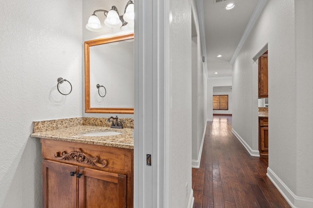 2100 Tremont Ave, Fort Worth, TX 76107 - bathroom with ornamental molding, hardwood / wood-style flooring, vanity, baseboards, and recessed lighting