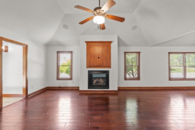 2100 Tremont Ave, Fort Worth, TX 76107 - unfurnished living room featuring vaulted ceiling, a glass covered fireplace, dark wood finished floors, a ceiling fan, and baseboards