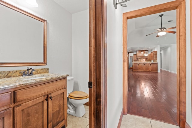 2100 Tremont Ave, Fort Worth, TX 76107 - bathroom featuring baseboards, toilet, a ceiling fan, vanity, and wood finished floors