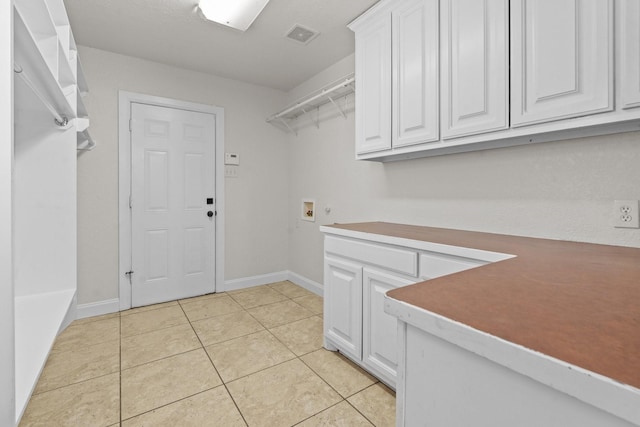 2100 Tremont Ave, Fort Worth, TX 76107 - laundry room with cabinet space, washer hookup, light tile patterned floors, and baseboards