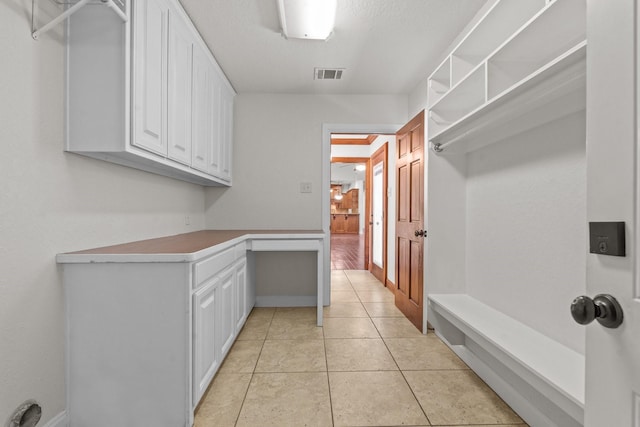 2100 Tremont Ave, Fort Worth, TX 76107 - laundry area featuring cabinet space and light tile patterned floors