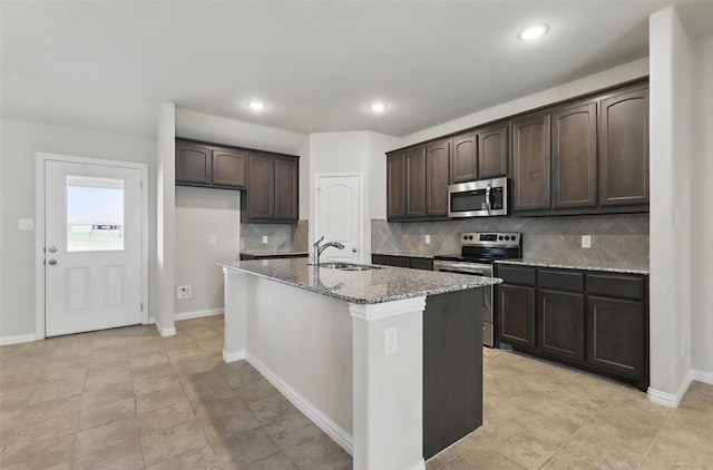 240 Springwood Ranch Loop, Springtown, TX 76082 - kitchen featuring stainless steel appliances, a sink, light stone counters, dark brown cabinetry, and tasteful backsplash