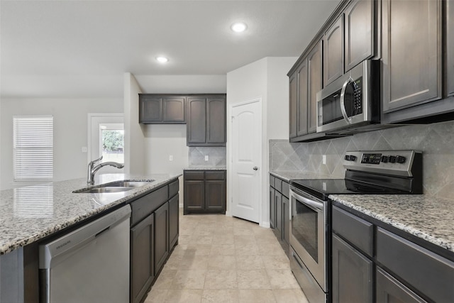240 Springwood Ranch Loop, Springtown, TX 76082 - kitchen featuring stainless steel appliances, a sink, light stone counters, tasteful backsplash, and recessed lighting