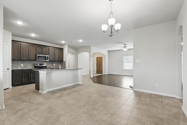 240 Springwood Ranch Loop, Springtown, TX 76082 - kitchen featuring stainless steel appliances, arched walkways, a ceiling fan, decorative backsplash, and a chandelier