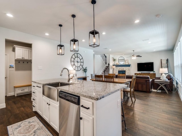 916 Timber Ridge Dr, Justin, TX 76247 - kitchen featuring dishwasher, a sink, dark wood finished floors, ceiling fan, and a kitchen island with sink