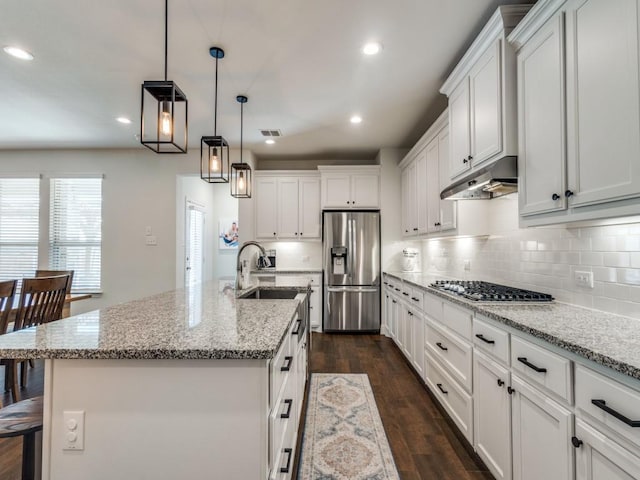 916 Timber Ridge Dr, Justin, TX 76247 - kitchen with appliances with stainless steel finishes, a sink, under cabinet range hood, white cabinets, and tasteful backsplash