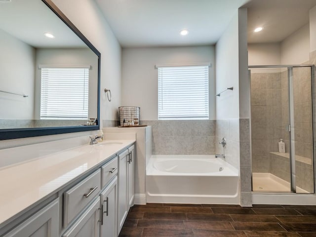 916 Timber Ridge Dr, Justin, TX 76247 - bathroom featuring vanity, a bath, a stall shower, wood finish floors, and recessed lighting