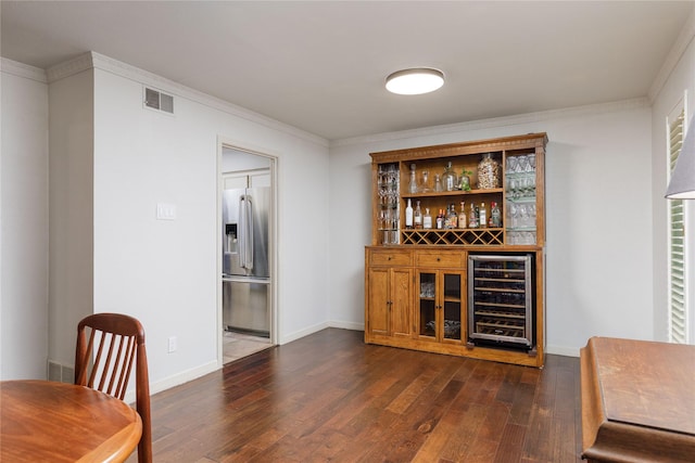 3212 Woodwind Ln, Dallas, TX 75229 - bar area featuring wine cooler, stainless steel refrigerator with ice dispenser, dark wood finished floors, ornamental molding, and baseboards