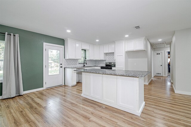 6225 Kentwood Pl, Fort Worth, TX 76112 - kitchen with appliances with stainless steel finishes, white cabinets, backsplash, light wood finished floors, and recessed lighting