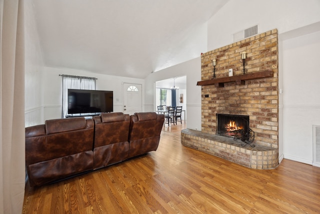 3812 Longmeadow Way, Fort Worth, TX 76133 - living room featuring wood finished floors, a brick fireplace, and high vaulted ceiling