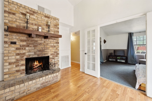 3812 Longmeadow Way, Fort Worth, TX 76133 - unfurnished living room with wood finished floors, a fireplace, baseboards, and french doors
