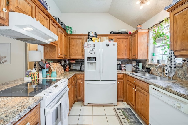 1112 Bayfield Dr, Denton, TX 76209 - kitchen with white appliances, under cabinet range hood, a sink, vaulted ceiling, and backsplash