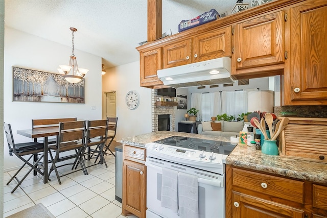 1112 Bayfield Dr, Denton, TX 76209 - kitchen featuring electric range, under cabinet range hood, light tile patterned floors, brown cabinetry, and a chandelier