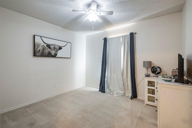 1112 Bayfield Dr, Denton, TX 76209 - bedroom with light colored carpet, a textured ceiling, a ceiling fan, and baseboards