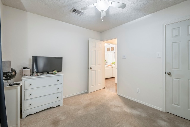 1112 Bayfield Dr, Denton, TX 76209 - bedroom featuring light carpet, a textured ceiling, baseboards, and a ceiling fan