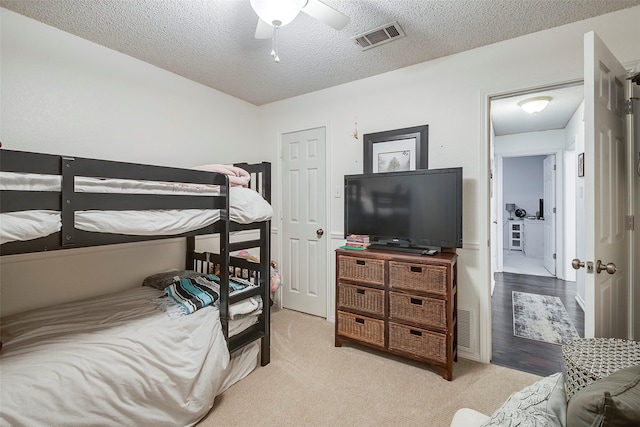 1112 Bayfield Dr, Denton, TX 76209 - bedroom featuring a textured ceiling, carpet, and a ceiling fan