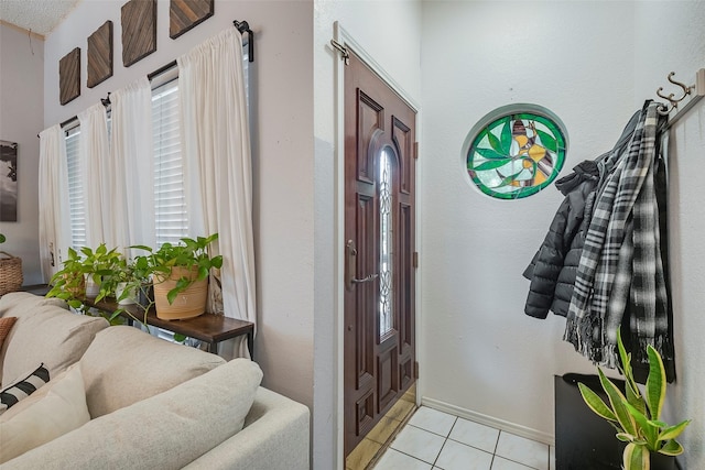 1112 Bayfield Dr, Denton, TX 76209 - foyer featuring light tile patterned floors and baseboards