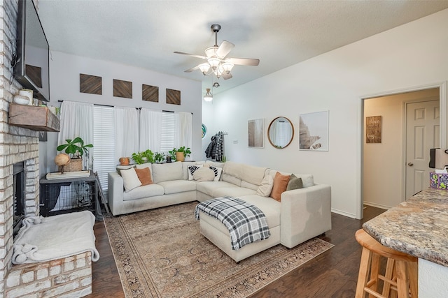 1112 Bayfield Dr, Denton, TX 76209 - living area with a fireplace, ceiling fan, and dark wood finished floors