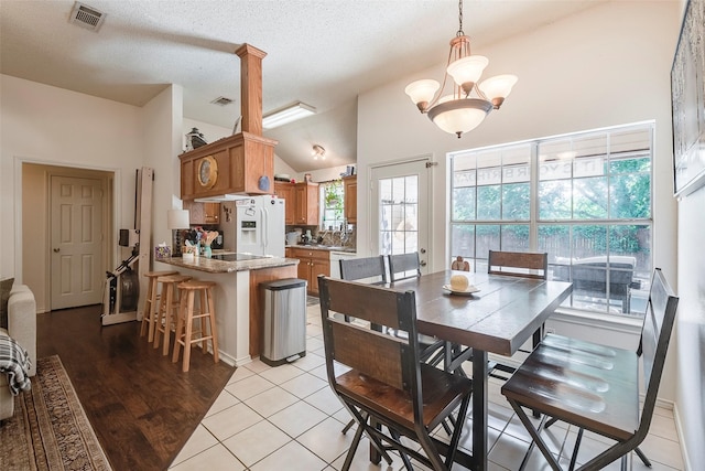 1112 Bayfield Dr, Denton, TX 76209 - dining space with a textured ceiling, light tile patterned flooring, and high vaulted ceiling