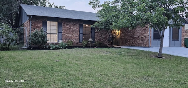 5524 King Dr, The Colony, TX 75056 - view of front of home featuring brick siding, a front yard, and roof with shingles