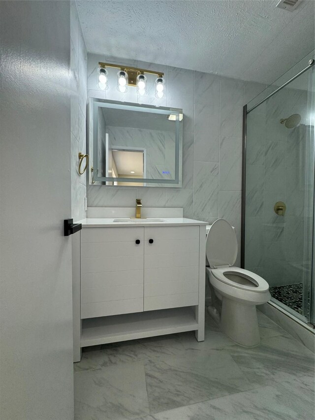 5524 King Dr, The Colony, TX 75056 - full bath with a shower stall, vanity, toilet, a textured ceiling, and marble finish floors