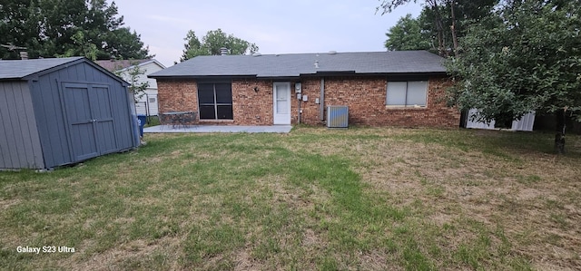 5524 King Dr, The Colony, TX 75056 - rear view of property with a storage unit, brick siding, a patio area, an outdoor structure, and a lawn