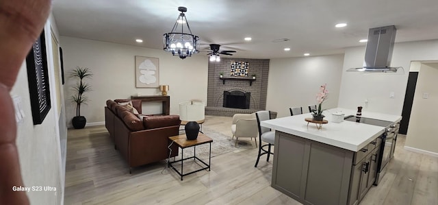 5524 King Dr, The Colony, TX 75056 - living room featuring light wood-style floors, a brick fireplace, recessed lighting, a ceiling fan, and a chandelier