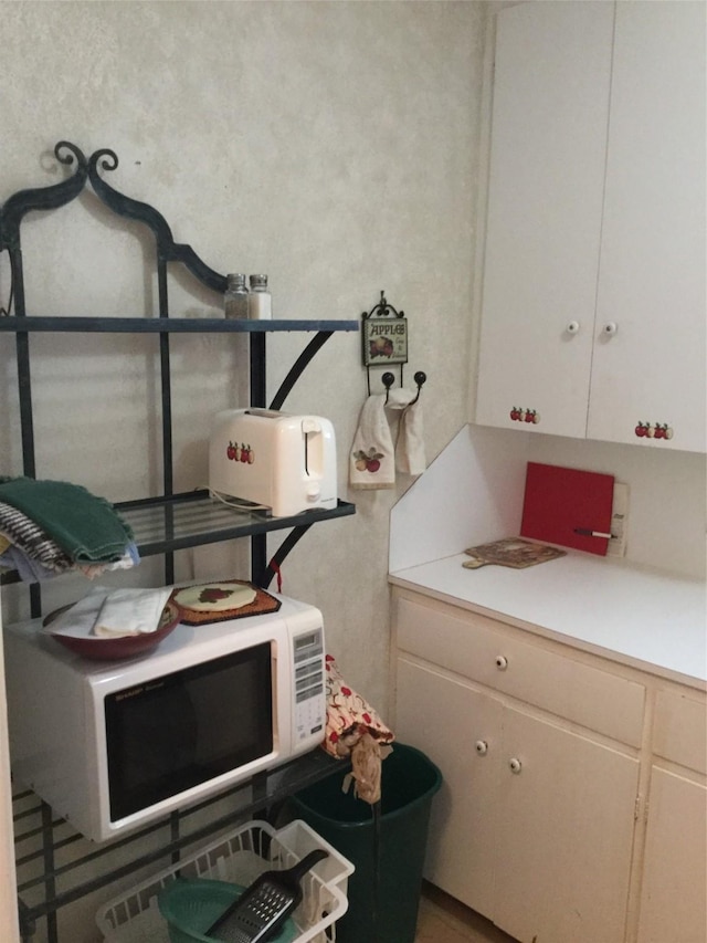 1014 N Sycamore St, Palestine, TX 75801 - kitchen with white microwave and light countertops