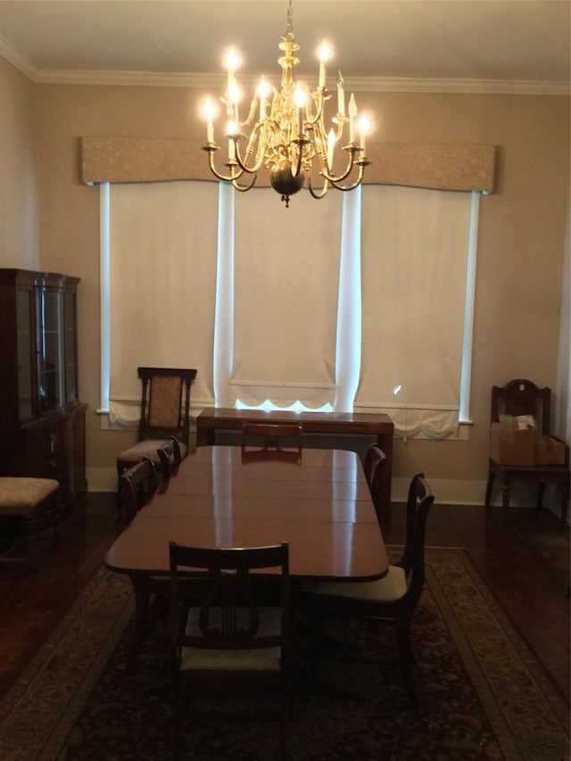 1014 N Sycamore St, Palestine, TX 75801 - dining area with wood finished floors, a chandelier, baseboards, and crown molding