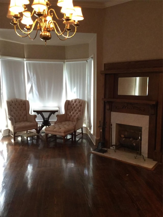 1014 N Sycamore St, Palestine, TX 75801 - living area featuring a chandelier, dark wood finished floors, a fireplace, and crown molding