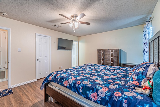 8110 Macgregor Dr, Arlington, TX 76002 - bedroom featuring wood finished floors, a ceiling fan, baseboards, and a textured ceiling