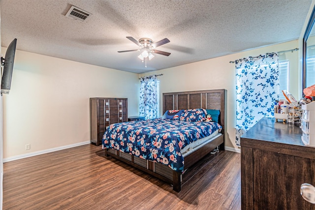 8110 Macgregor Dr, Arlington, TX 76002 - bedroom featuring wood finished floors, baseboards, a textured ceiling, and ceiling fan