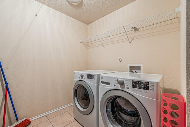 8110 Macgregor Dr, Arlington, TX 76002 - washroom with washer and dryer, light tile patterned floors, and a textured ceiling