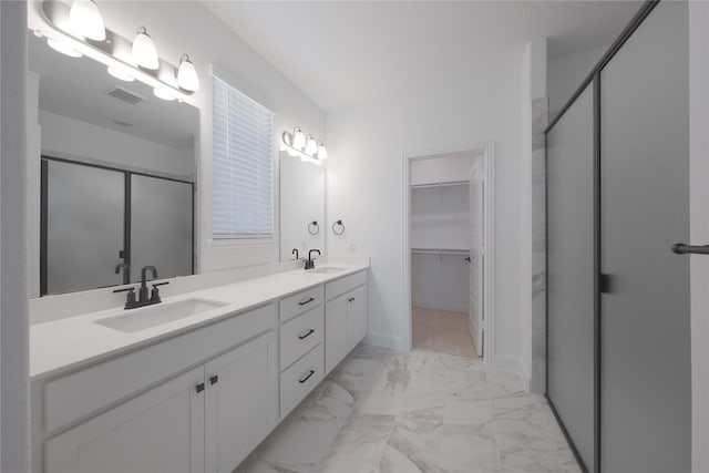 2301 Miramar Dr, Little Elm, TX 75068 - bathroom featuring a stall shower, double vanity, marble look tiles, a spacious closet, and baseboards