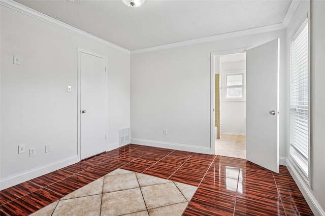 2143 Lake By Dr, Irving, TX 75060 - spare room with tile patterned flooring, crown molding, healthy amount of natural light, and baseboards