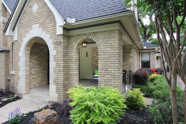 1138 N Windomere Ave, Dallas, TX 75208 - doorway to property featuring a shingled roof and brick siding