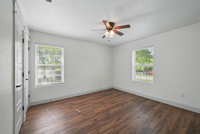 930 Baker St, Denison, TX 75020 - unfurnished room with plenty of natural light, dark wood-style floors, and a ceiling fan