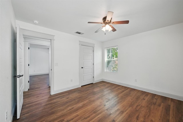 930 Baker St, Denison, TX 75020 - unfurnished bedroom with dark wood finished floors, baseboards, and ceiling fan