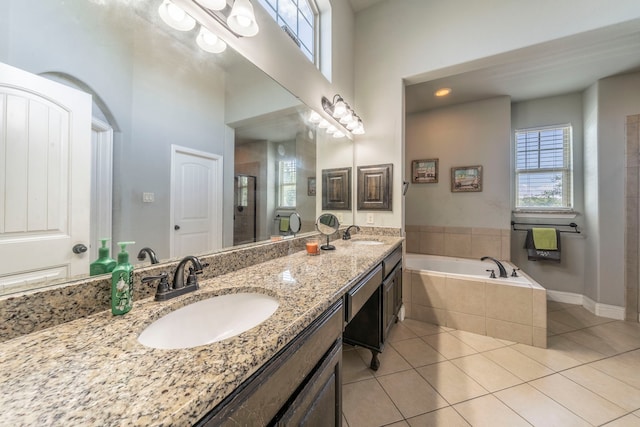 1005 Caudle Ln, Savannah, TX 76227 - bathroom with tile patterned flooring, healthy amount of natural light, a garden tub, and a stall shower