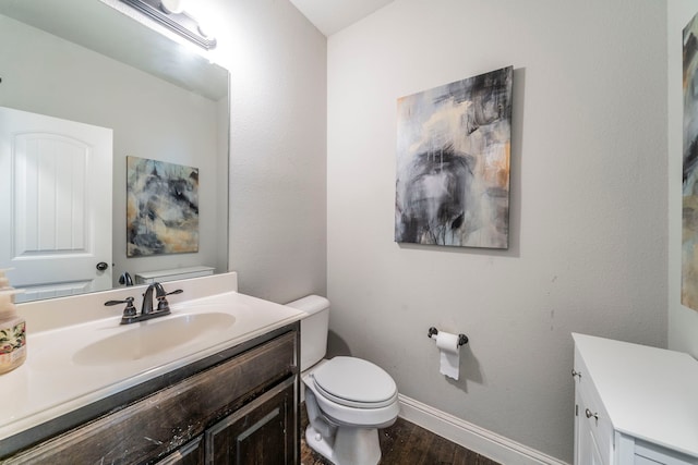 1005 Caudle Ln, Savannah, TX 76227 - bathroom featuring toilet, vanity, wood finished floors, and baseboards