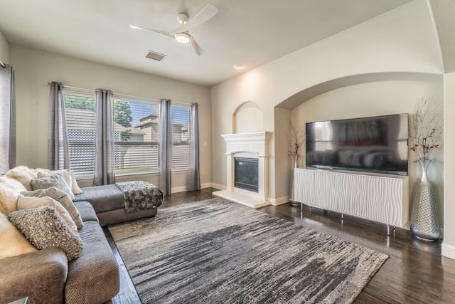 1005 Caudle Ln, Savannah, TX 76227 - living area with wood finished floors, ceiling fan, a glass covered fireplace, and baseboards
