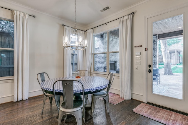 dining space featuring a chandelier, dark wood-type flooring, crown molding, and baseboards