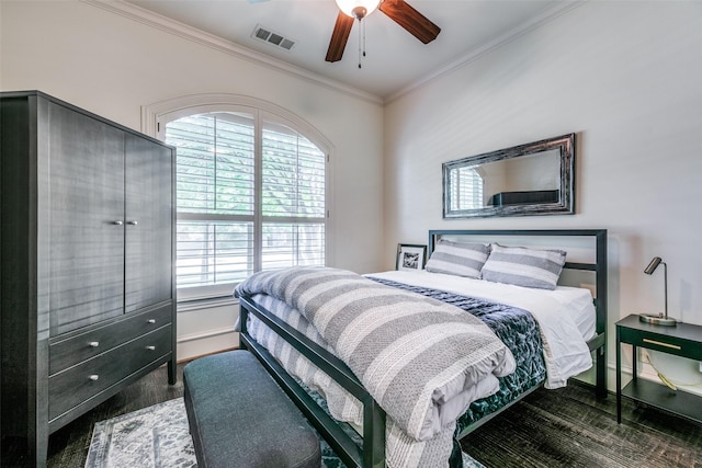 bedroom with crown molding, multiple windows, wood finished floors, baseboards, and ceiling fan